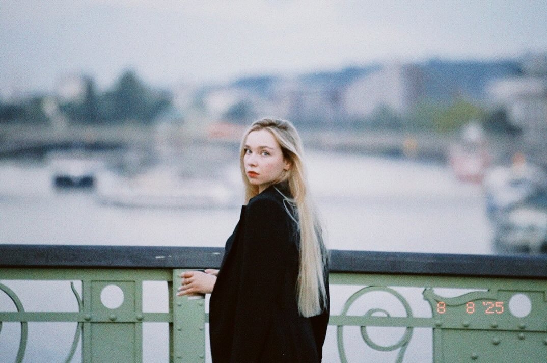 Portrait of a woman looking back on a bridge