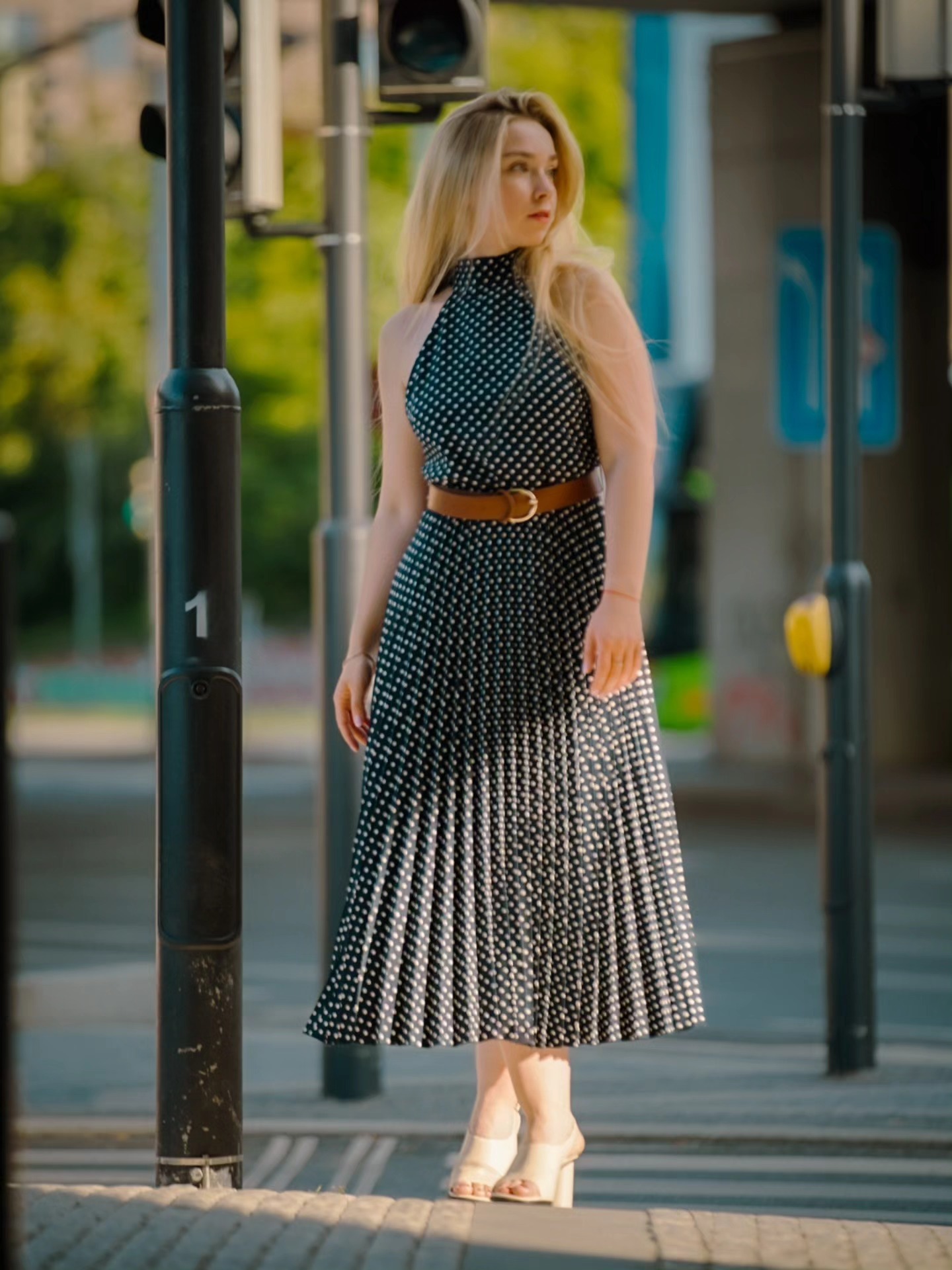 Portrait of a woman in a polka dot dress on a city street
