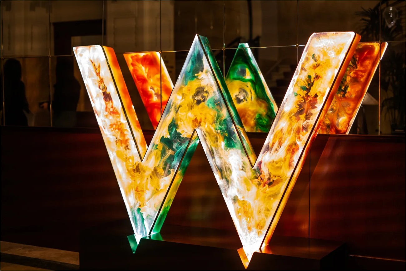 Illuminated W monogram sculpture in a hotel lobby